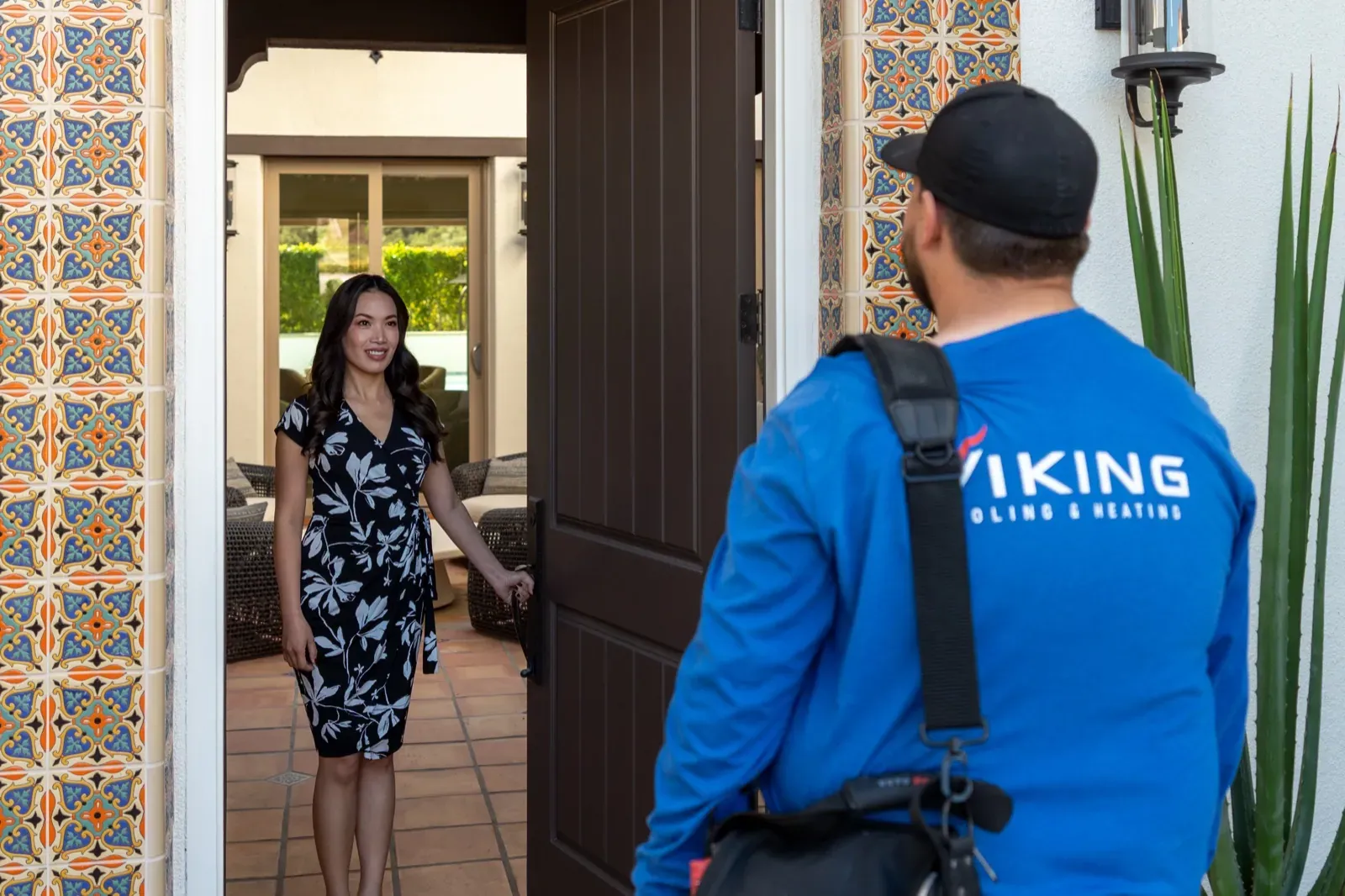 A Viking technician greeting a Tucson customer at their front door