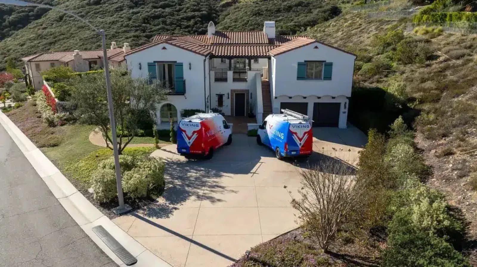 Two Viking Cooling & Heating vans parked at a San Diego County home