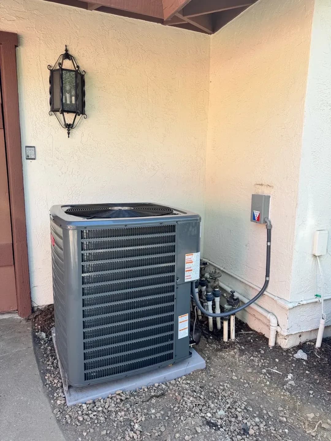An outdoor AC unit's electrical disconnect box in the Tucson sun