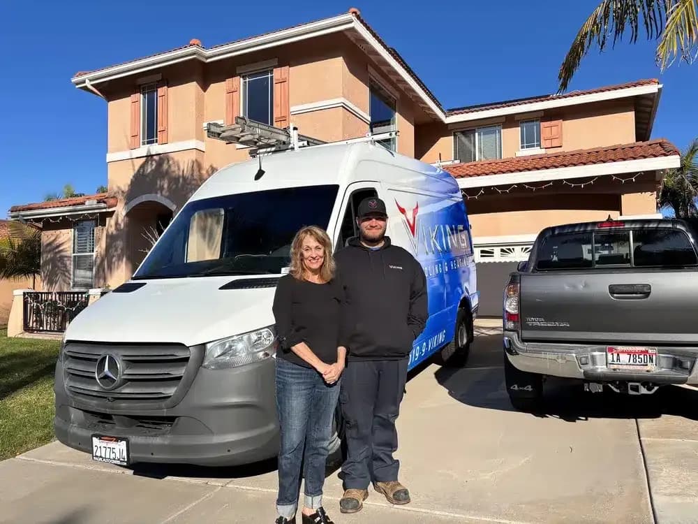 A Viking technician greeting a homeowner at the door