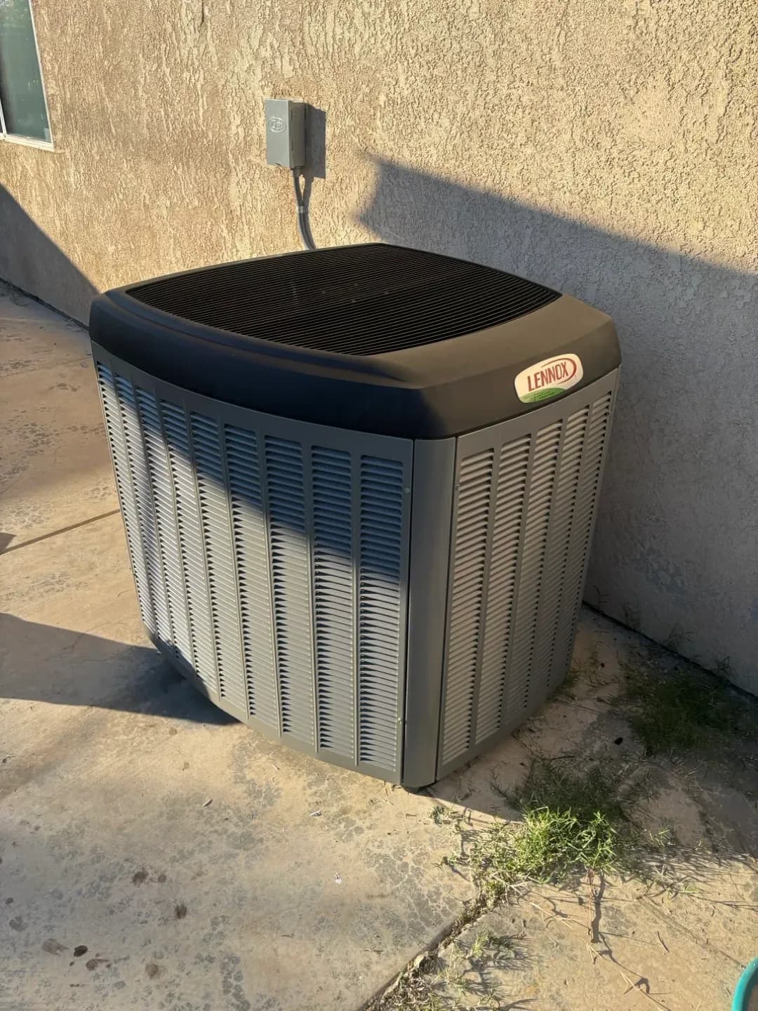 An outdoor AC condenser running through a hot Tucson summer