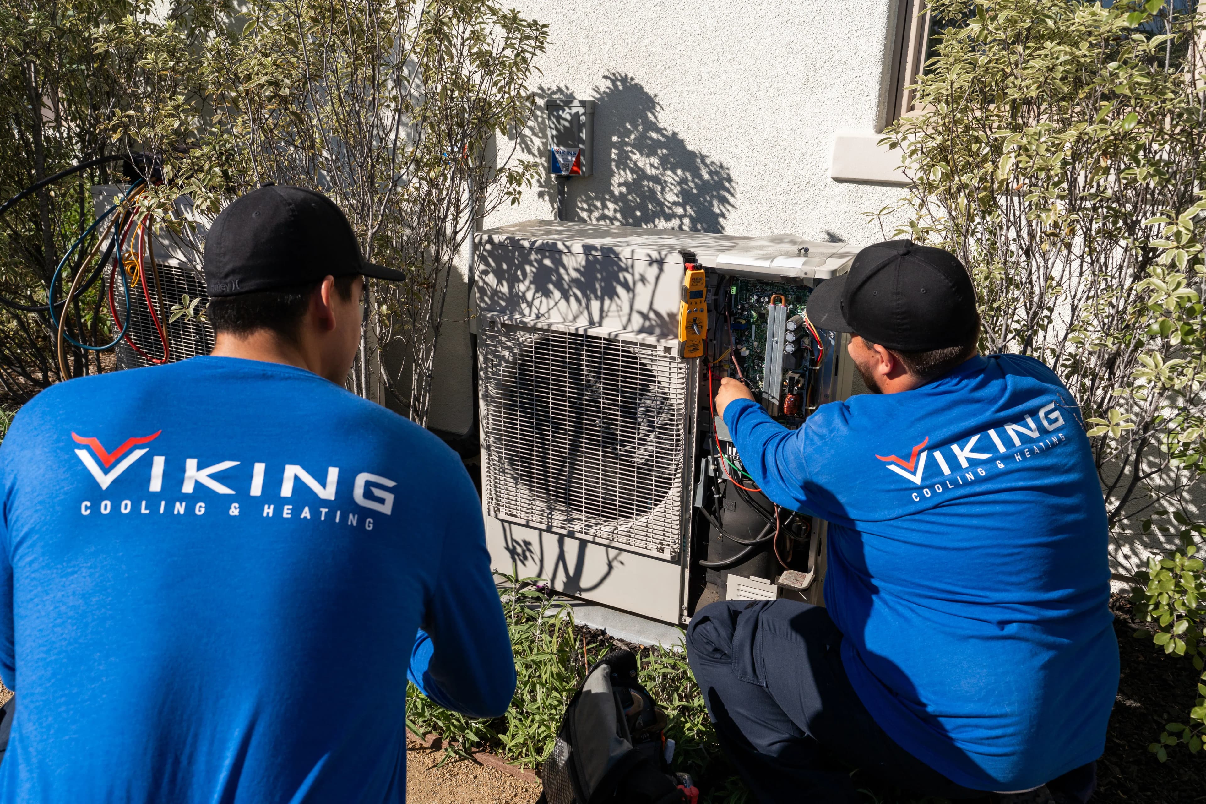 Viking technicians inspecting an AC system for a refrigerant coil leak
